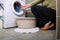 Woman loading the washing machine in bathroom