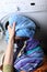 Woman loading the washing machine in bathroom