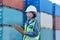 Woman logistic worker, shipping checklist and working at shipyard freight container distribution port. Stock management