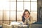 A woman with long brown hair sitting on a sofa