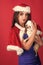 Woman with long brunette hair in xmas dress with puppy