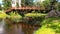 Woman in long dress walk bridge and reflections on river water