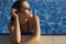 woman with long hair in bikini relaxing in swimming pool