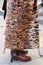 Woman with long tiger fur coat before Salvatore Ferragamo fashion show, Milan Fashion Week street style on