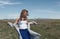 Woman with long tousled hair next to the wind turbine