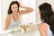 Woman look at herself bathroom mirror reflection