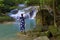 Woman look waterfall  at Erawan Waterfall and  natural