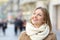 Woman looking above in winter in the street