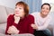 Woman looking away after conflict, daughter tries reconcile