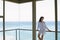 Woman Looking Away While Leaning On Railing In Balcony