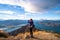 A woman looking at the beautiful landscape of the mountains and Lake Wanaka. Roys Peak Track, South Island, New Zealand. I