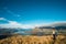 A woman looking at the beautiful landscape of the mountains and Lake Wanaka. Roys Peak Track, South Island, New Zealand. I