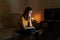 Woman looking bored with laptop at night