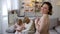 Woman looking at camera, daughter and granny playing tablet, togetherness