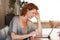 Woman looking at computer thinking sitting at table