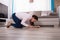 Woman Looking At Hardwood Floor Through Magnifying Glass