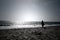 A woman looking at infinite horizon on a bright sunny day at a seashore