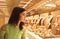 Woman looking at jewelry in store window. Girl chooses silver, gold, diamonds, precious stones