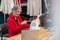 Woman looking at laptop pointing at sewing machine