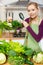 Woman looking magnifier at vegetables