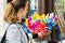 Woman looking at many colorful children windmills.