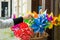 Woman looking at many colorful children windmills.