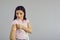 Woman looking at medical patch on hand standing over studio copy space