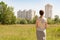 Woman looking at modern residential buildings