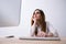 Woman looking at monitor in office