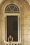 Woman looking out of window in Old Havana, Cuba