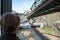 woman looking out the window of Wuppertaler Schwebebahn, Wuppertal suspension