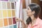 Woman looking in paints and crafts stores colors samples