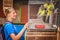 Woman looking at parrots in a cage