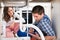 Woman Looking At Plumber View From Under The Sink