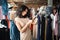 Woman looking at a price tag while shopping dress