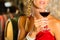 Woman looking at red wine glass in cellar