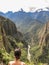 Woman looking at the river Urubamba on a hiking path in Machu Picchu