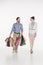 woman looking at smiling husband carrying shopping bags