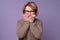 Woman looking stressed and nervous with hands on mouth biting nails