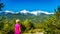 Woman looking at the Tantalus Mountain Range with snow covered peaks of Alpha Mountain, Serratus and Tantalus Mountain