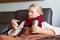 Woman looking at thermometer. Female hands holding a digital thermometer.