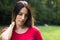 Woman looking thoughtful. Walking arround, outdoors, in the park.