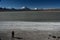 Woman looking three volcanos and a lake