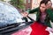 Woman Looking At Ticket Fine For Parking Violation On Car