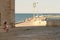 Woman looking at tourists at trani harbour, Apulia, Italy. cathedral sunset