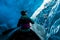 Woman looking up from canoe inside ice cave in Alaska