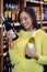 Woman looking at wine bottle in grocery section