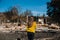 Woman lookinh at her burned home after fire disaster