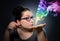 Woman looks at the mystical colored smoke.