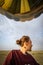 Woman looks out to the Masai Mara Reserve while in the air in a hot air balloon safari